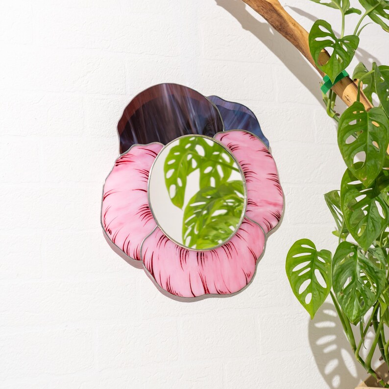 Stained glass pansy mirror wall decor with monstera plant reflection