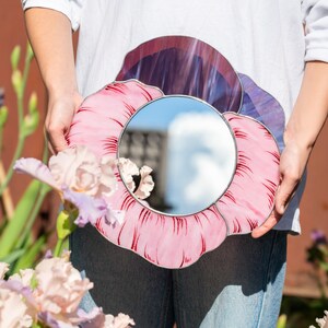 Pink pansy stained glass mirror with flowers in soft natural light