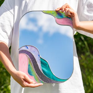 Stained glass colorful waves mirror held by person outdoor modern artistic glass home decor piece