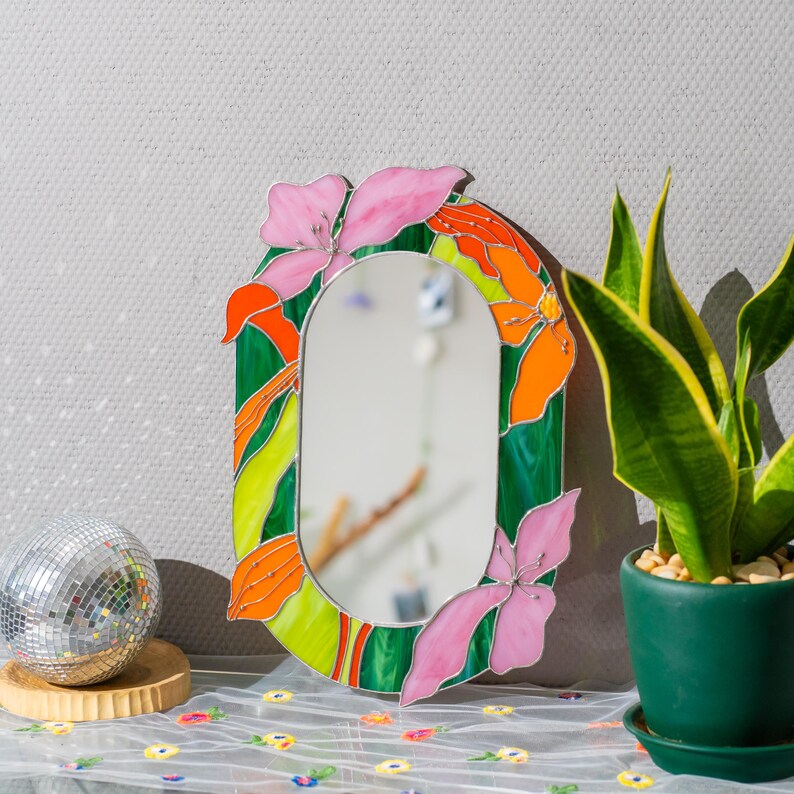 Stained glass floral mirror styled with plants and soft light in home decor scene