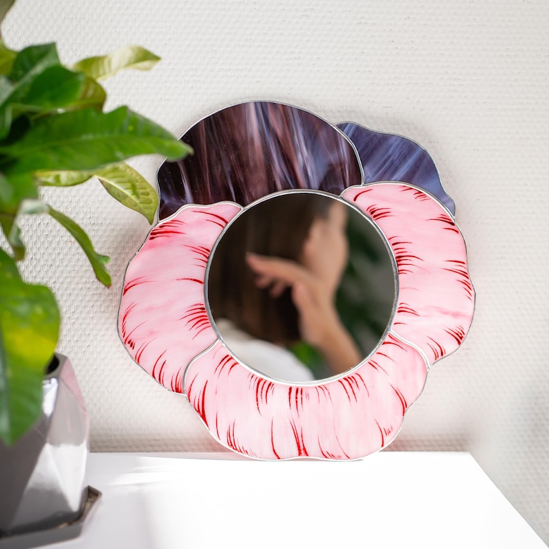 Handmade stained glass pansy mirror with soft blurred portrait reflection