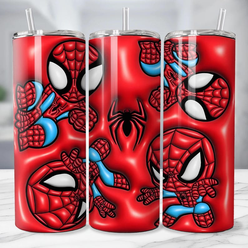 May include: A set of three red insulated tumblers featuring a Spider-Man design. The design includes multiple illustrations of Spider-Man in various poses, along with a black spider emblem. Each tumbler has a clear straw and a silver lid.