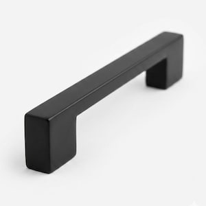 Tiradores modernos de color negro mate para armarios y cajones, herrajes minimalistas para muebles de cocina y baño.
