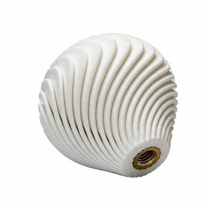 May include: A white, spherical object with a textured, layered design. The layers create a wave-like pattern around the sphere. A brass-colored threaded insert is visible at the base. The object is likely a decorative element or a knob.