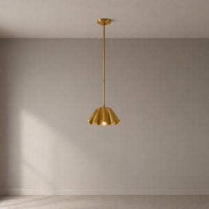May include: A gold-colored pendant light fixture with a scalloped shade. The light hangs from a slender rod attached to a circular ceiling mount. The shade has a textured surface and a single light bulb is visible.