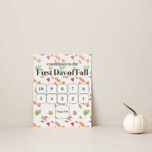 Può includere: Un cartello rettangolare per il conto alla rovescia con il testo "countdown to the First Day of Fall" sopra una griglia di caselle numerate da 10 a 1 e una casella finale "Happy Fall", su uno sfondo di foglie arancioni, rosse e verdi.