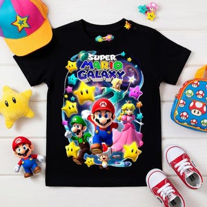 May include: Black t-shirt featuring a Super Mario Galaxy graphic with Mario, Luigi, and Princess Peach. Accessories include a colorful cap, backpack, plush star, and red sneakers.