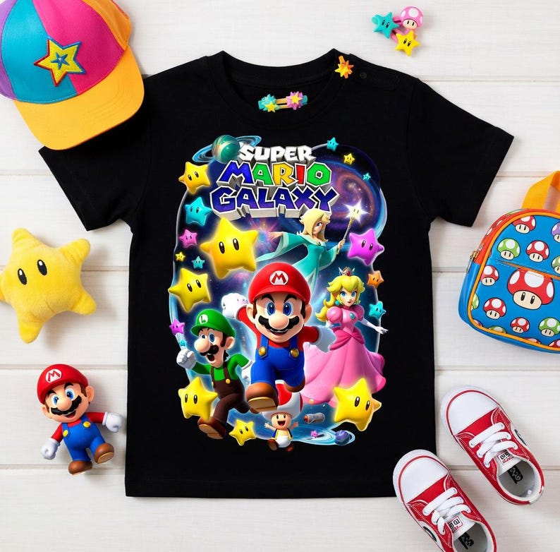 May include: Black t-shirt featuring a Super Mario Galaxy graphic with Mario, Luigi, and Princess Peach. Accessories include a colorful cap, backpack, plush star, and red sneakers.