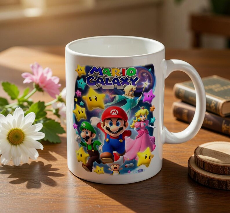 May include: White ceramic mug featuring a colorful graphic of Mario, Luigi, Princess Peach, and other characters from the Mario Galaxy game. The mug has a large handle and the words "Mario Galaxy" are displayed on the front.