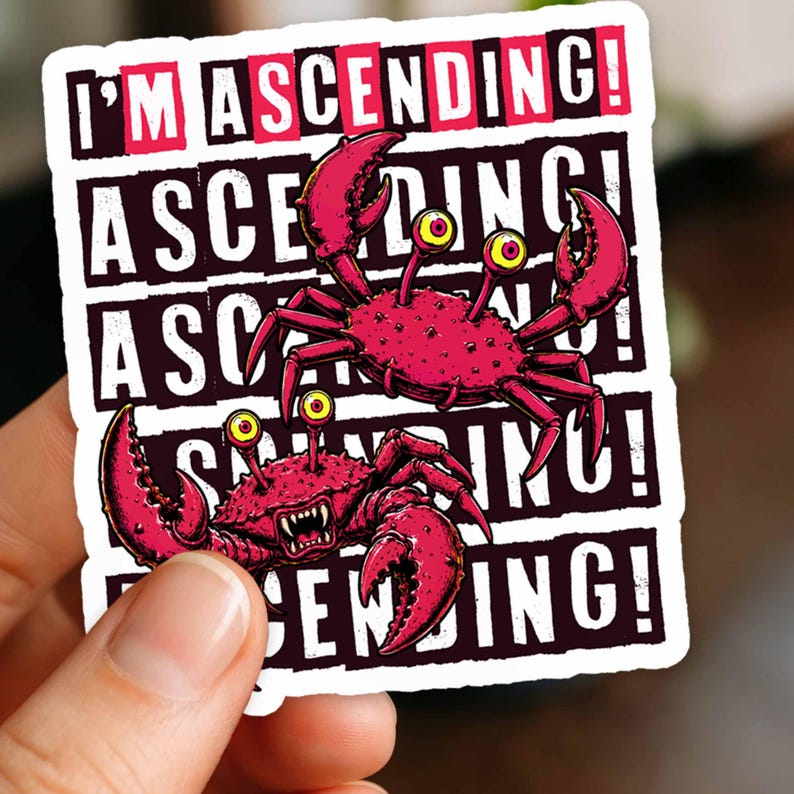 May include: A die-cut sticker featuring two pink crabs with yellow eyes and sharp teeth. The background consists of repeating black horizontal bars with the white text I'M ASCENDING! printed in a bold, sans-serif font across the entire design.