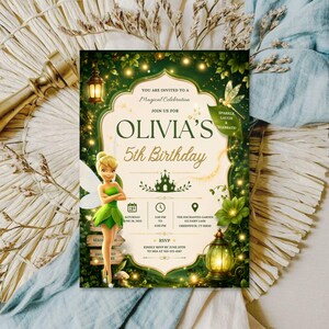 May include: A rectangular birthday invitation card featuring a green forest theme with Tinker Bell, a lantern, and a castle illustration. The text reads: You are invited to a magical celebration, Olivia's 5th Birthday, Saturday June 28, 2025, 2:00 PM to 6:00 PM, The Enchanted Garden, 123 Fairy Lane, Greenwich, CT, and RSVP to Mia at 555-123-4567.