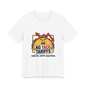 Könnte beinhalten: Weißes T-Shirt mit einem Comic-Taco, der ein Schild mit der Aufschrift "NO TACO TARIFFS" hält. Der Taco hat einen wütenden Gesichtsausdruck, und ein roter Pfeil zeigt nach oben. Der Text "THREATEN. TREND. BACKTRACK." steht darunter.