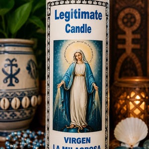 May include: A tall cylindrical glass prayer candle filled with blue wax. The label features the text Legitimate Candle and VIRGEN LA MILAGROSA above and below a central illustration of the Virgin Mary standing on a globe with a serpent.