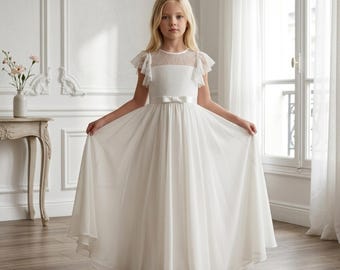 May include: A white formal dress with a sheer skirt and a lace bodice. The dress features a bow at the waist and short, ruffled sleeves. The dress is suitable for a flower girl or special occasion.