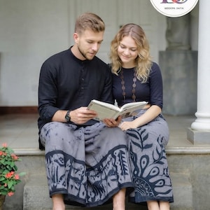 May include: A black long-sleeved shirt with a mandarin collar and a black three-quarter sleeve top paired with matching grey batik-patterned sarongs featuring dark grey leaf and geometric motifs, with a logo reading LADY & GENTS MODERN BATIK.