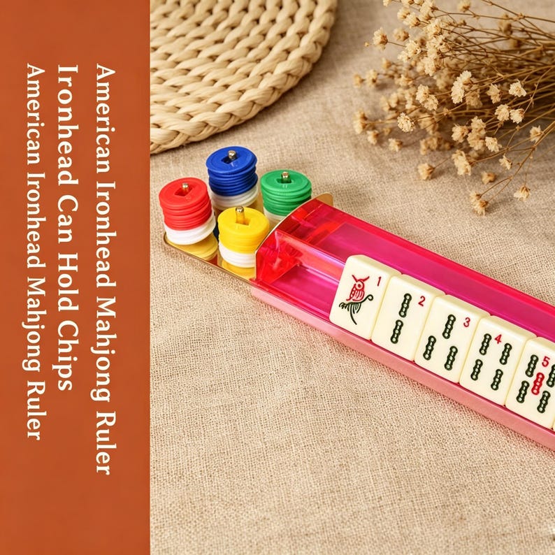 May include: A pink translucent plastic Mahjong ruler with a set of stacked red, blue, green, and yellow chips. The ruler displays cream-colored tiles with numbers and symbols. Text on the image reads: American Ironhead Mahjong Ruler Ironhead Can Hold Chips.