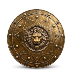 May include: A circular bronze-toned shield featuring a prominent, high-relief lion head sculpture at its center. The surface is decorated with a star-shaped pattern, raised circular studs, and a beaded border along the outer edge of the shield.
