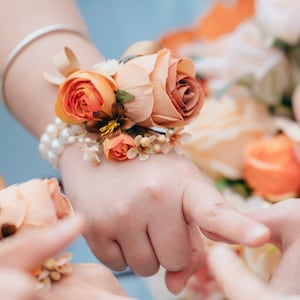 Autumn orange roses wrist corsages-Bridesmaids' wrist corsages with white pearls