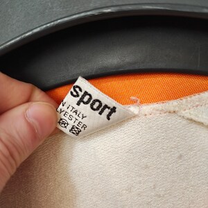 Puede incluir: Una taza de cer&aacute;mica blanca con un asa negra y el texto "But First, Coffee" en un estilo manuscrito. La taza est&aacute; sobre una superficie blanca. La taza mide aproximadamente 10 cm de alto.