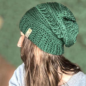 May include: A green crocheted beanie with a brown leather tag that says "Handmade with Love".