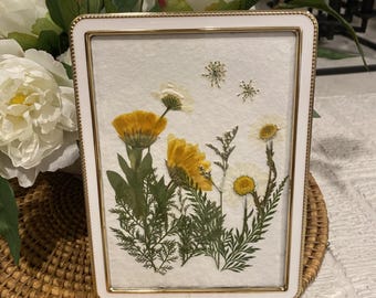 White and Gold Beaded Frame with pretty saffron yellow marigolds, daisies and ferns.