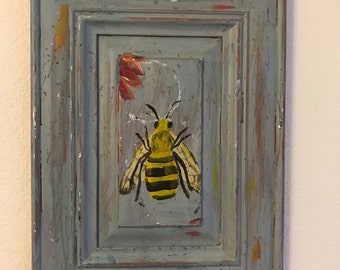 Bee on distressed wood cabinet