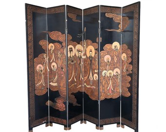 May include: A six-panel folding screen with a black background and a detailed painting. The artwork depicts figures in traditional attire against a backdrop of clouds. The screen's borders feature a decorative geometric pattern in a warm, earthy tone.