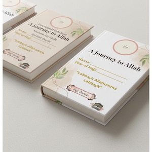 May include: A stack of hardback journals titled "A Journey to Allah" is shown. The white covers feature watercolour designs and English and Arabic text. Each journal provides space for personal details and the year of Hajj.