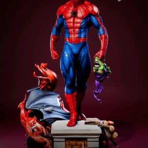 May include: A detailed statue of Spider-Man in a dynamic pose, clad in his iconic red and blue suit. He stands atop a brick-like structure, holding a Green Goblin mask. The base features sculpted elements and the Sigma One logo.