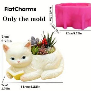 May include: A white cat-shaped planter holding a yellow book, filled with succulents and small red berries. The planter is 11 inches long and 7 inches high. The image also shows a pink mold, 4.72 inches long and 3.15 inches high. Text reads "FlatCharms Only the mold."