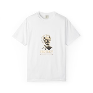 May include: White t-shirt featuring a portrait of Leon Trotsky in shades of brown and gold. The word "TROTSKY" is printed below the portrait, along with the phrase "Permanent Revolution".