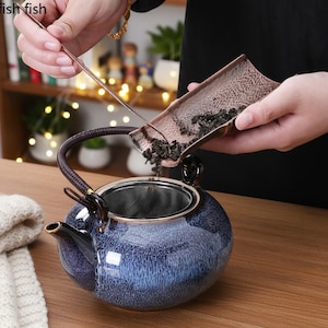 May include: A set of three ceramic mugs with a speckled, matte finish. The mugs are in shades of blue, green, and white. Each mug has a simple, modern design, perfect for coffee or tea. The mugs are approximately 4 inches tall.