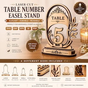 May include: A laser-cut wooden table number easel stand featuring the number 5, with an oval frame and decorative leaf accents. The design includes a sturdy base and is available in four sizes ranging from 4.6 x 7.5 cm to 10.6 x 17.2 cm.
