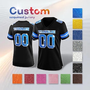 May include: Black sequined jersey with blue and white accents. The jersey features the text "YOURNAME" and "TEAMNAME" with the number "00" in a sparkling blue design. The image also shows color swatches.