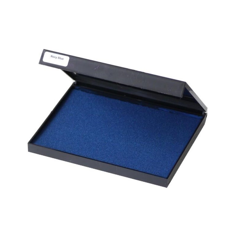 May include: A navy blue ink pad in a black plastic case. The ink pad is open, revealing a rectangular, saturated blue ink surface. The lid is slightly ajar, with a small label that reads "Navy Blue".