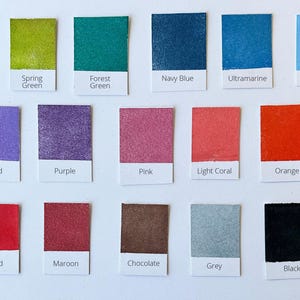 May include: Colour chart with 18 paint swatches, each with a name label. The colours include emerald green, spring green, forest green, navy blue, ultramarine, powder blue, orchid, purple, pink, light coral, orange, red, maroon, chocolate, grey, and black.