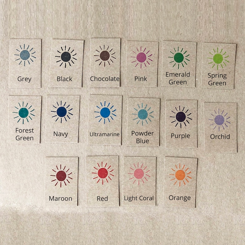 May include: A chart of 18 colour swatches, each with a sun graphic and a colour name. The colours include grey, black, chocolate, pink, emerald green, spring green, forest green, navy, ultramarine, powder blue, purple, orchid, maroon, red, light coral, and orange.