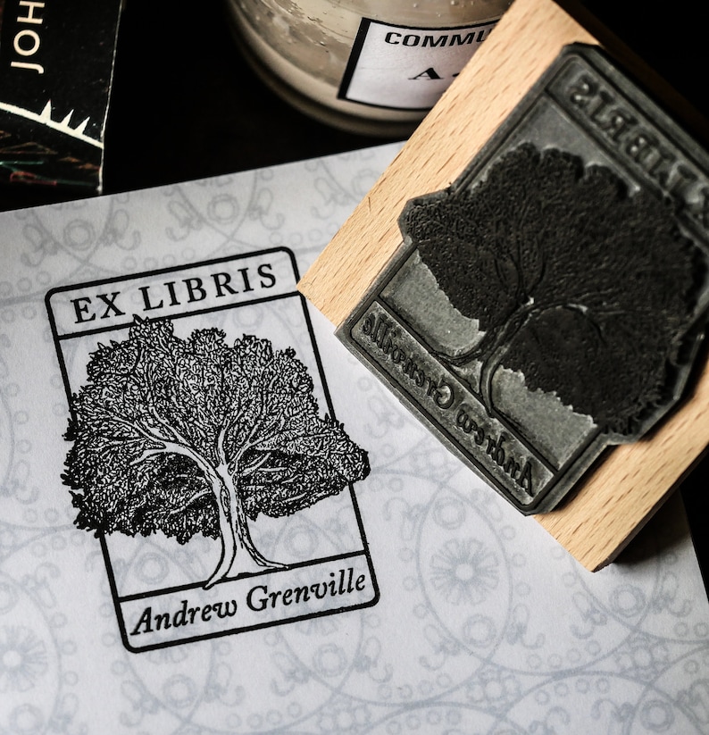 May include: A black and white illustration of a tree with the text "Ex Libris" and "Andrew Grenville" on a white background with a decorative pattern.