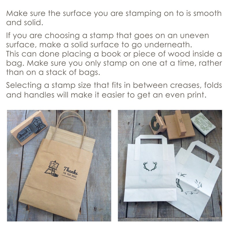 May include: Two paper bags with handles. One bag is brown with a stamp that says "Thanks for your order". The other bag is white with a stamp of antlers. Both bags are on a wooden surface.