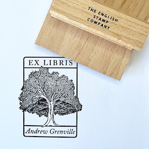 May include: Black and white stamp with a tree and the text "Ex Libris Andrew Grenville". The stamp is on a wooden block with the text "The English Stamp Company".
