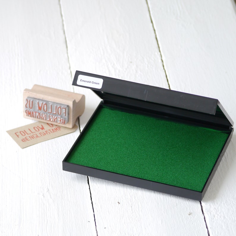 May include: An open ink pad with a bright green ink pad and a black plastic case. The ink pad is labeled "Emerald Green".