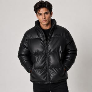 May include: A black puffer jacket with a smooth, leather-like finish, featuring a high collar, a full-length front zipper, and horizontal quilted sections. A small, rectangular black patch with embossed text is visible on the upper chest.