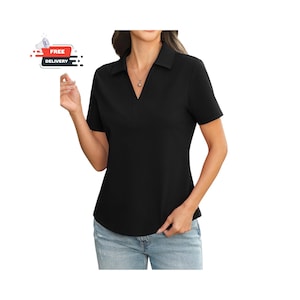May include: Black short-sleeve collared shirt with a V-neck design. The shirt has a classic polo style and is made of a smooth, solid fabric. The shirt is paired with blue jeans. The image also includes a "FREE DELIVERY" graphic.