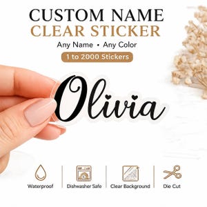 May include: A clear die-cut sticker featuring the name Olivia in black cursive script with two small heart accents. The text reads CUSTOM NAME CLEAR STICKER, Any Name, Any Color, 1 to 2000 Stickers, Waterproof, Dishwasher Safe, Clear Background, and Die Cut.