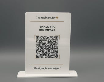 May include: A white rectangular acrylic sign with a stand featuring the text You made my day with a heart icon, the words SMALL TIP, BIG IMPACT, a central QR code, and the text Thank you for your support printed in black and gold ink.