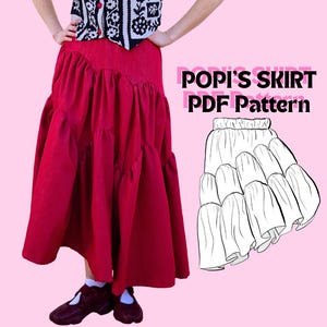 May include: A long, solid red skirt with a tiered, gathered design. Next to the skirt is a black and white line drawing illustration of the same tiered skirt design with the text POPI'S SKIRT PDF Pattern printed in bold black capital letters.