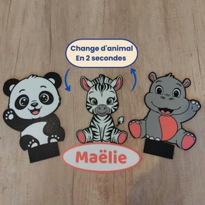 Könnte beinhalten: Drei Tierausstanzungen: ein Panda, ein Zebra und ein Nilpferd. Der Panda ist schwarz und weiß, das Zebra ist schwarz und weiß und das Nilpferd ist grau und rosa. Der Text "Change d'animal En 2 secondes" befindet sich in einem blauen Oval. Der Name "Maëlie" befindet sich in einem weißen Oval.