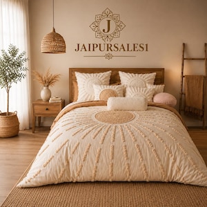 May include: A cream-colored bedding set featuring a tufted sunburst pattern with a central circle and radiating lines. The set includes two square pillows, a cylindrical bolster pillow, and a duvet cover, all displayed on a wooden bed frame.