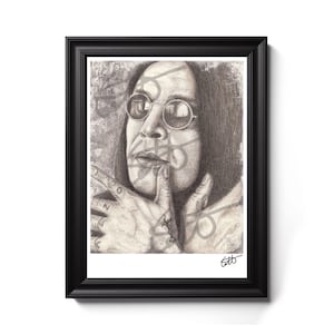 May include: A black and white graphite portrait drawing of a person with long dark hair wearing round glasses, with hands positioned near the face, featuring visible finger tattoos and a signature in the bottom right corner, encased in a black frame.