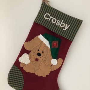 Beautiful dog stocking handmade in the US. This adorable stocking has a dog handstitched to the front of the stocking. The dog stocking is sure to be treasured for years to come. Treat your furry friend with their very own dog stocking.